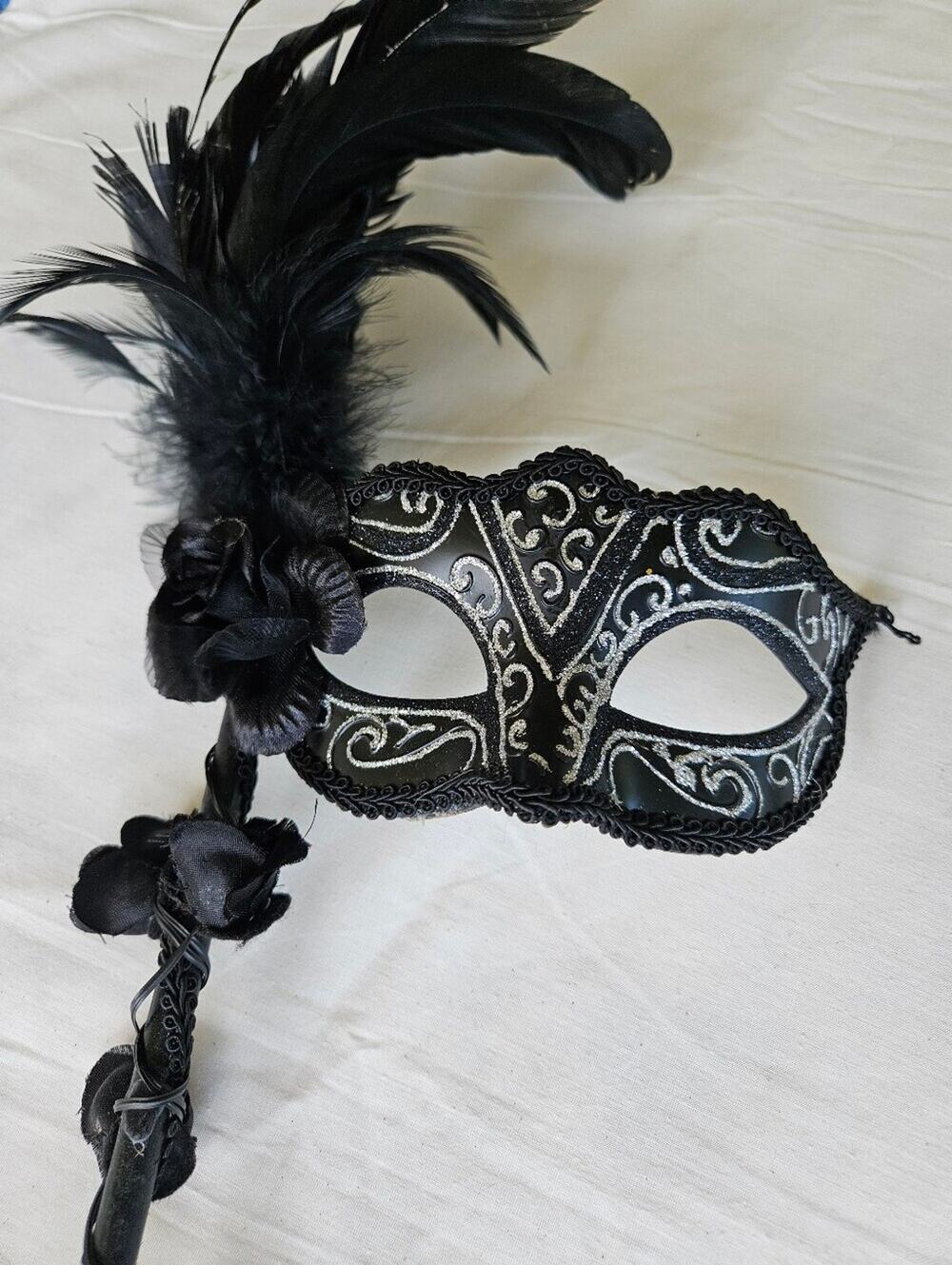 Black Masquerade Mask On A Stick With Silver Accents And Feathers